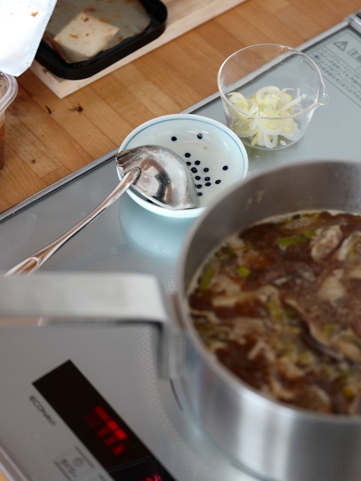 お玉置きとしてコンロ横に置かれた三寸皿 雪